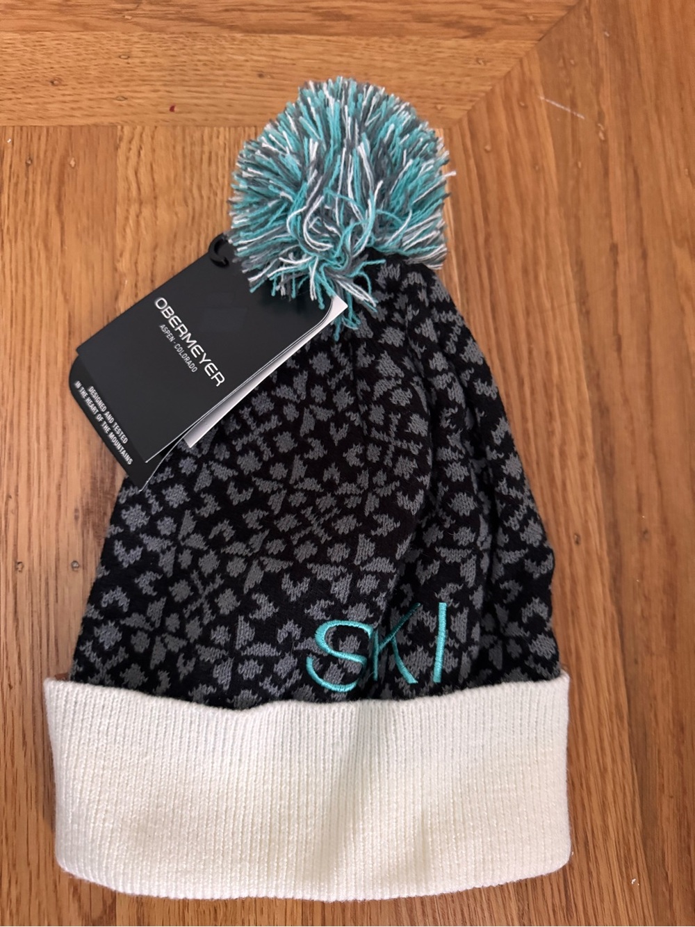 Obermeyer Black & Teal Pom Knit Ski Hat with Cream Cuff